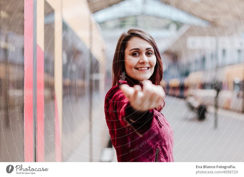 beautiful caucasian woman in train station waiting to travel. Travel and lifestyle concept city public transport boards young trip screen passenger wagon