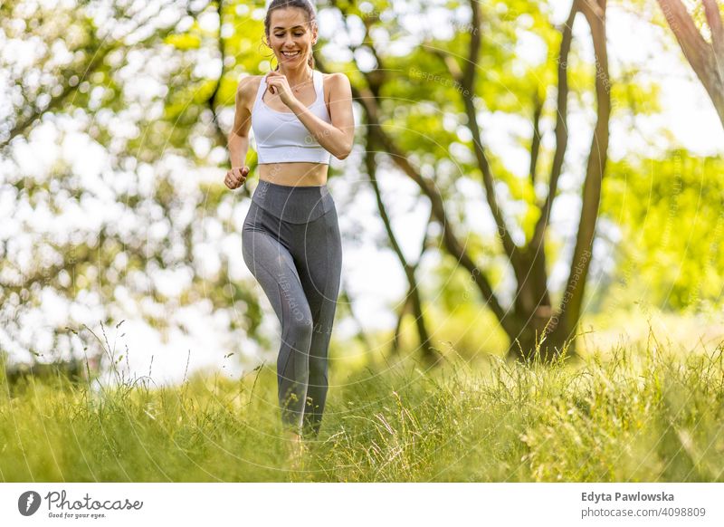 Fit young woman exercising in nature natural girl people female recreation healthy wellbeing lifestyle active vitality outdoors adult outside attractive