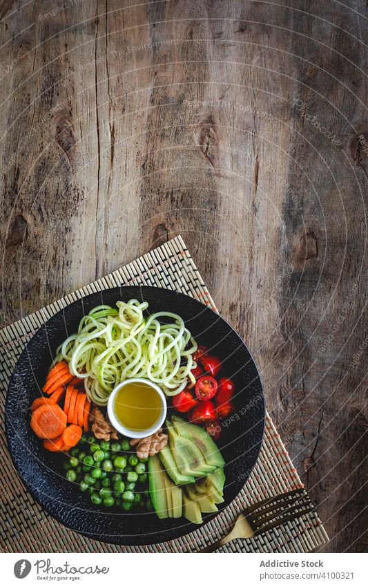 Zucchini raw vegan pasta with assorted vegetables. Vegan food zucchini vegetarian healthy detox lunch salad diet spaghetti cuisine organic green meal noodles