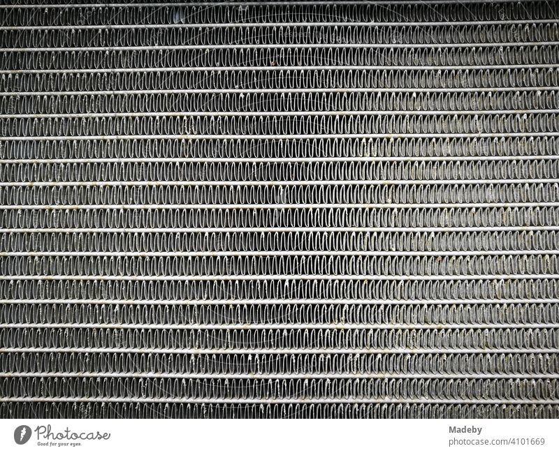 Honeycomb structure of the cooling fins of a water cooler of a Swedish sedan of the eighties in a workshop in Lage near Detmold in Ostwestfalen-Lippe, Germany