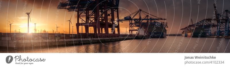 Large sunset panorama of a container terminal in Hamburg shipyard fine unloading editorial burchardkai daylight elbe river transportation system handling export