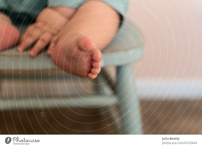 Close up of sweet chubby baby feet and hands; baby seated in turquoise wood chair independent child foot toddler sit toes care human kid childhood little family
