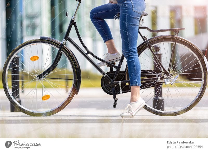 Legs of a young woman on a bicycle active Bicycle Bike On The Move commuter transport cycling biking healthy eco-friendly ecological enjoying lifestyle adult