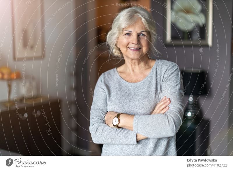 Smiling senior woman in her home people one person mature pensioners retiree retired retirement old elderly gray hair caucasian adult lifestyle beautiful