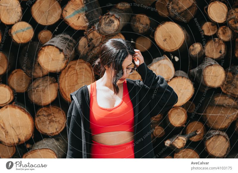 Young woman in fitness clothes thinking in front of a pile of trunks african american happy female compete workout ecofriendly copy-space jog escape marathon