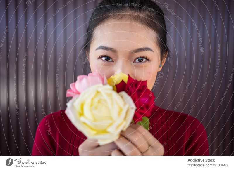 Asian lady showing rose bouquet at camera woman smile florist asian flower plant ethnic chinese japanese young culture green hobby turtleneck workshop bloom