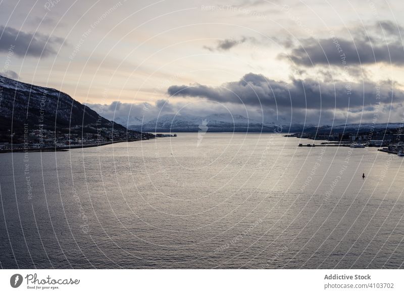 Landscape of calm bay middle islands on cloudy weather landscape sea city overcast mountain tranquil peaceful tormso norway seascape nature water ocean blue