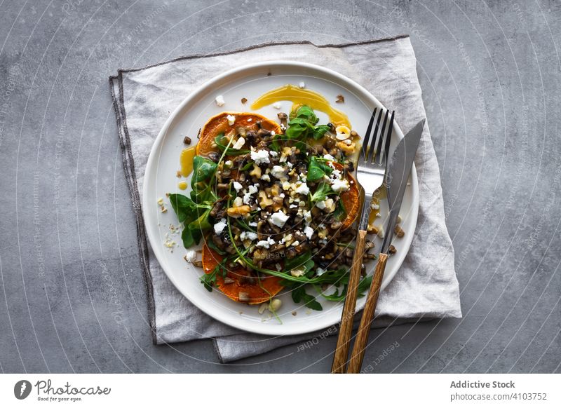 Plate with delicious salad and fork fresh lunch sweet potato baked dish plate kitchen healthy food meal vegetable herb rosemary buckwheat cheese nut silverware