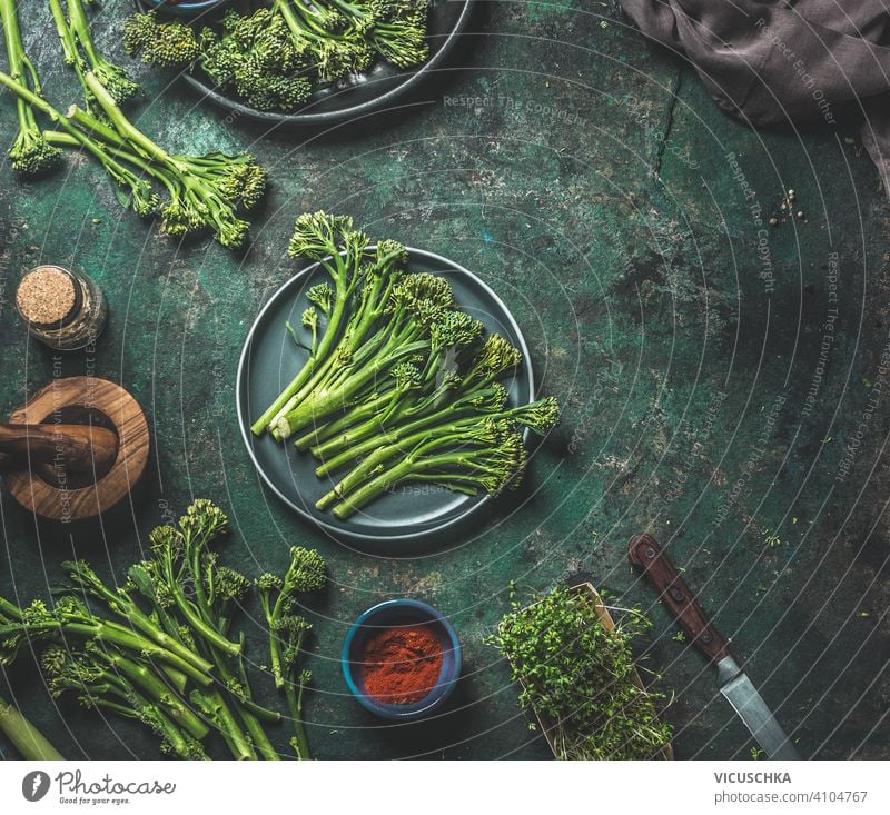 Wild broccoli on dark rustic background . Cooking preparation. Top view. Healthy food wild cooking top view healthy food kitchen table meal woman holding