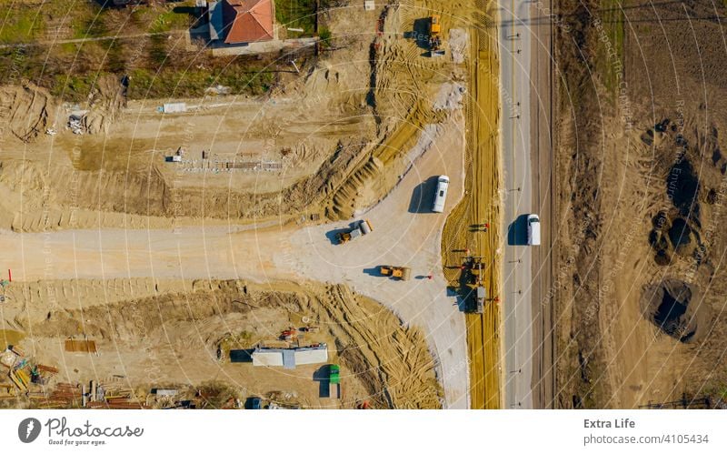 Aerial view on grader as leveling sand over construction site for new traffic roundabout Above Align Alignment Base Building Site Circle Circular