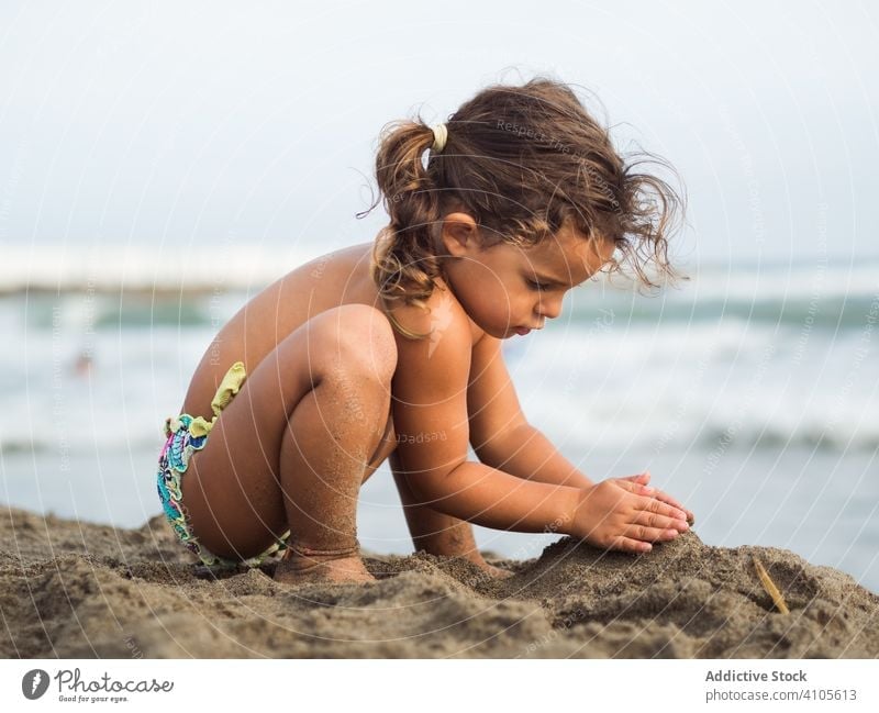 Cute little girl on the beach. Baby is resting near the sea. Summer  holidays. Girl in