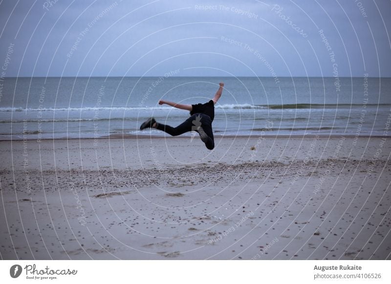 Man doing acrobatic in the beach. Moody weather and rain moody sky moody weather moody atmosphere nature background nature photography nature lovers