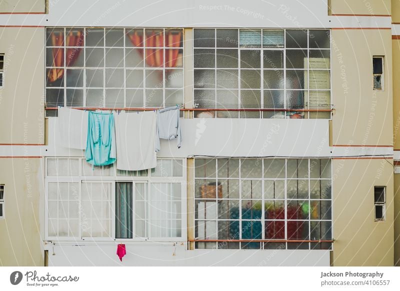 Old and new windows in a bit obsolete condominium in Faro, Portugal apartments flat faro algarve detail pattern laundry portugal social clothes townhouse