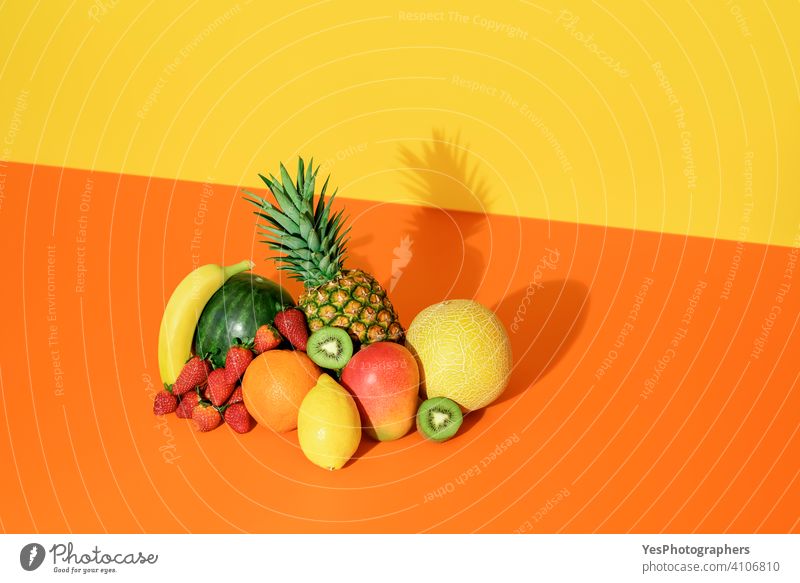 Tropical fruits isolated on a colored background. Fresh summer fruits. ananas assorted banana cantaloupe citrus colorful colors copy space creative cut out