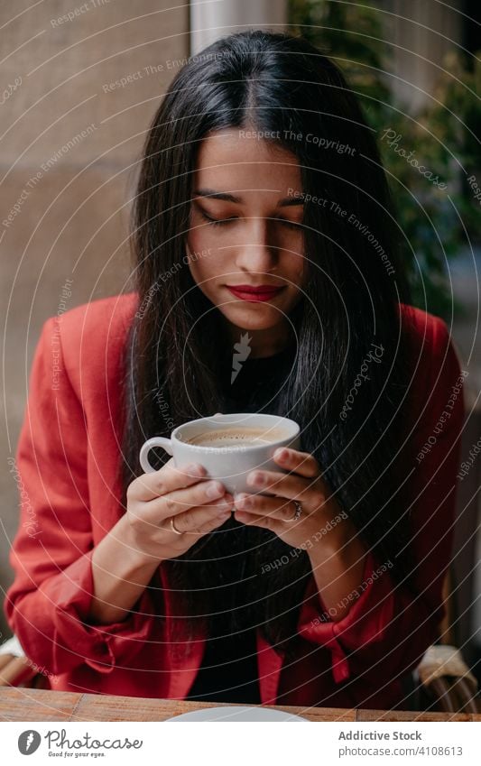 Woman drinking coffee in cafe - a Royalty Free Stock Photo from Photocase