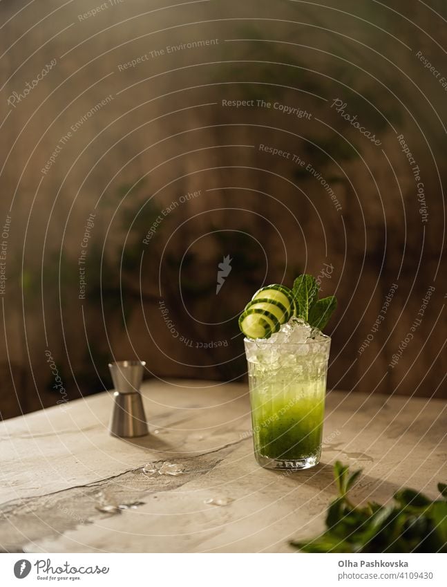 Still life with cucumber drink with ice and mint green slice organic refreshing homemade diet bar leaf color antioxidant vegan nutrition rustic lemonade