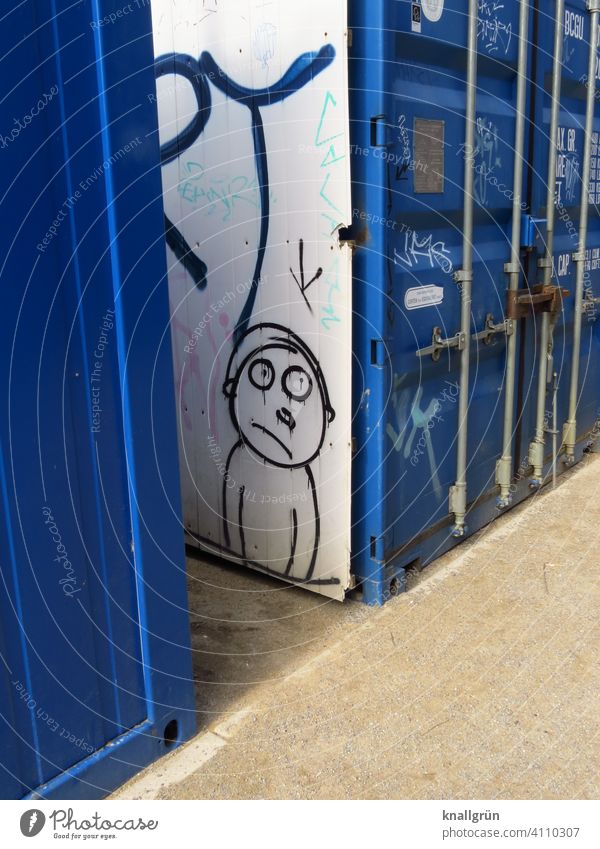 Storage container with graffiti Graffiti Stick figure Looking Container Blue White Exterior shot Deserted suffering Asking look big eyes Figure sandy soil Brown