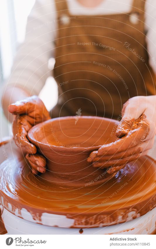 Artisan crafting earthenware in workshop artisan pottery handmade clay crockery circle person ceramic spin equipment master utensil jar creative professional