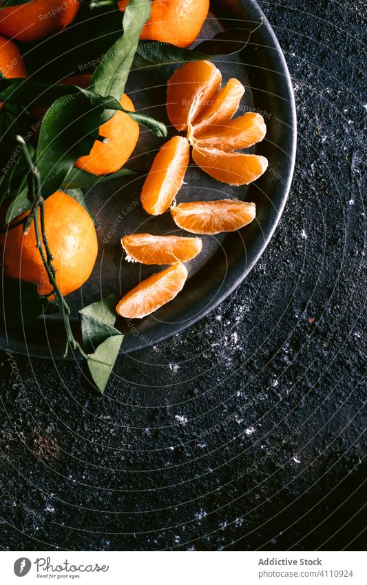 Fresh juice and tangerines on black table fresh ripe fruit rough napkin plate mug food organic citrus healthy natural delicious rustic vitamin sweet ingredient