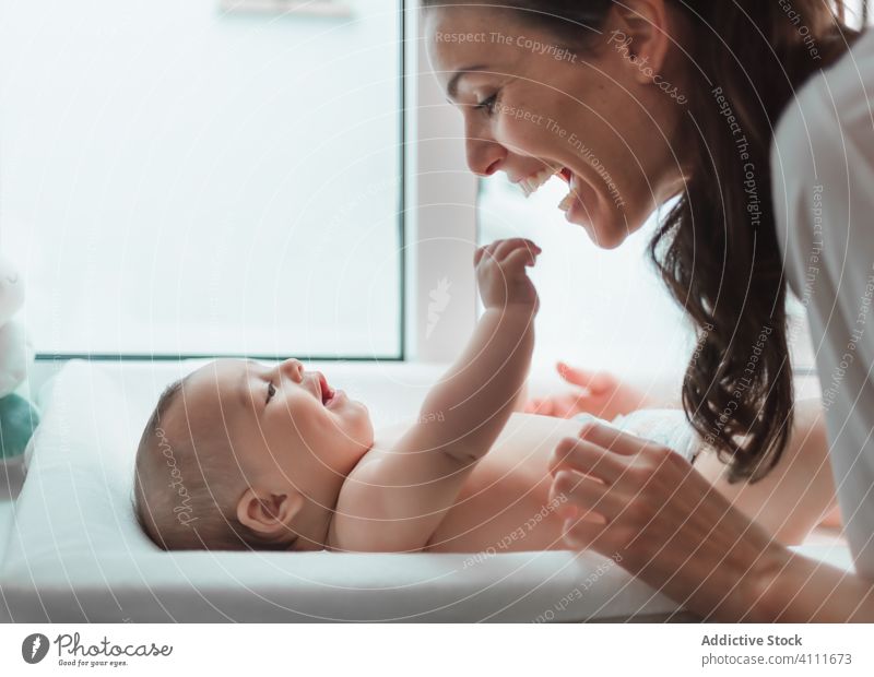 Joyful mother and little baby at home smile child care kid innocent cute adorable love parent relax laugh enjoy satisfied comfort happy small tender soft rest