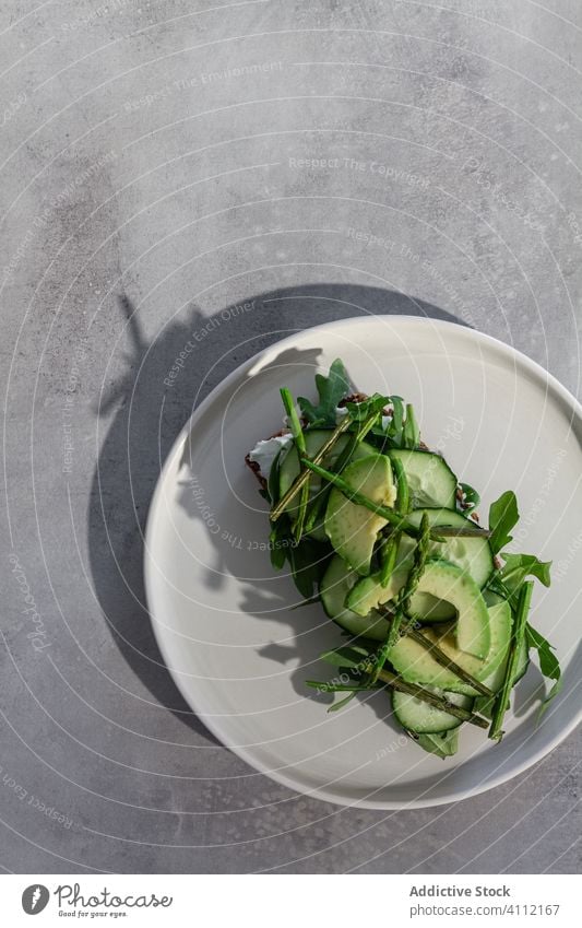 Delicious toast with fresh vegetables and herbs on plate green healthy vegetarian avocado cucumber natural food bread sandwich meal delicious tasty lunch