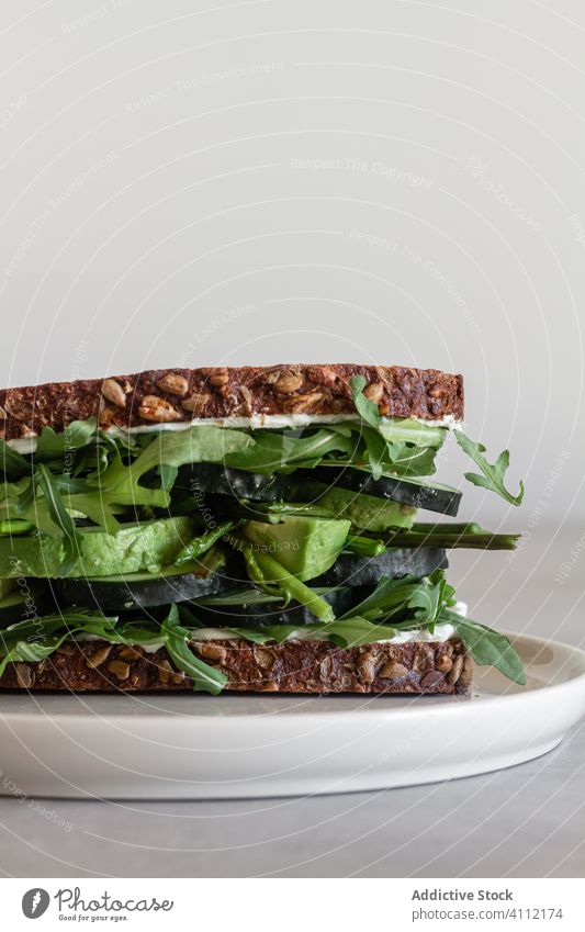 Healthy sandwich with green vegetables and herbs healthy natural fresh toast wholegrain food bread arugula avocado cucumber meal delicious tasty lunch nutrition