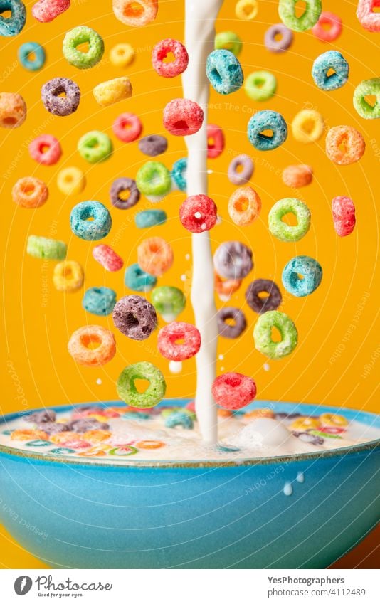 Milk and cereal poured in a bowl. Preparing breakfast, creative layout assorted background blue bright cereal bowl cereals close-up colorful colors cornflakes