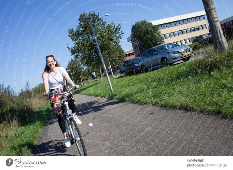 Woman on bicycle to Rotterdam Bicycle Street Lifestyle Happy youthful Cycling