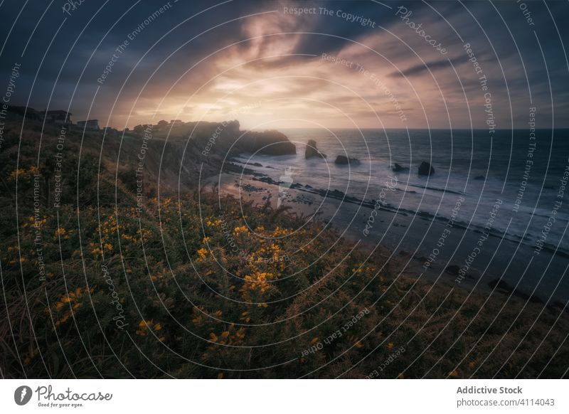 Magnificent scenery of rocky coast and troubled ocean foam waves during sunset sea stormy water cliff sky shore splash coastline power cantabria seascape