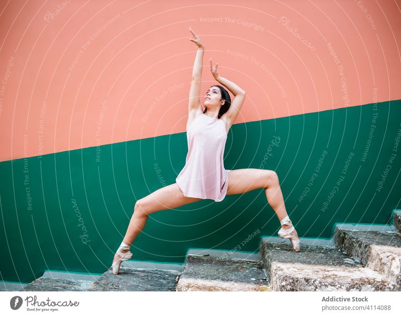 Slim woman dancing on steps dance grace concept arms raised tiptoe wall young slim female elegant ballerina perform dancer move ballet flexible motion balance