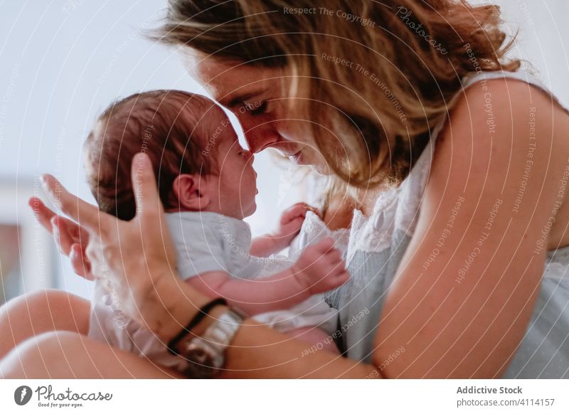 Happy mother holding newborn child happy woman baby care together love motherhood smile kid parent adorable childhood innocent infant little cute comfort