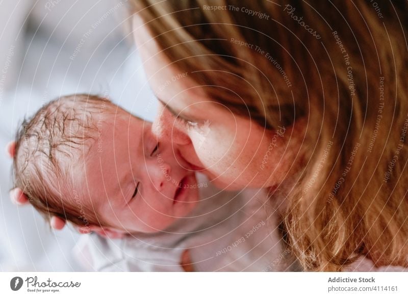 Happy mother holding newborn child happy woman baby care together love motherhood smile kid parent adorable childhood innocent infant little cute comfort