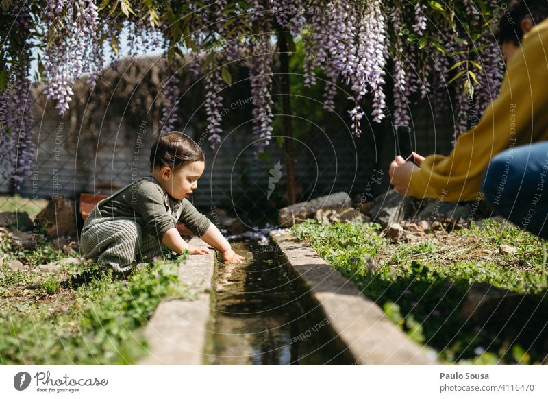 Mother photographing child playing with water Mother with child Child 1 - 3 years Caucasian color Playing Water Curiosity Innocent explore Cute Woman Love