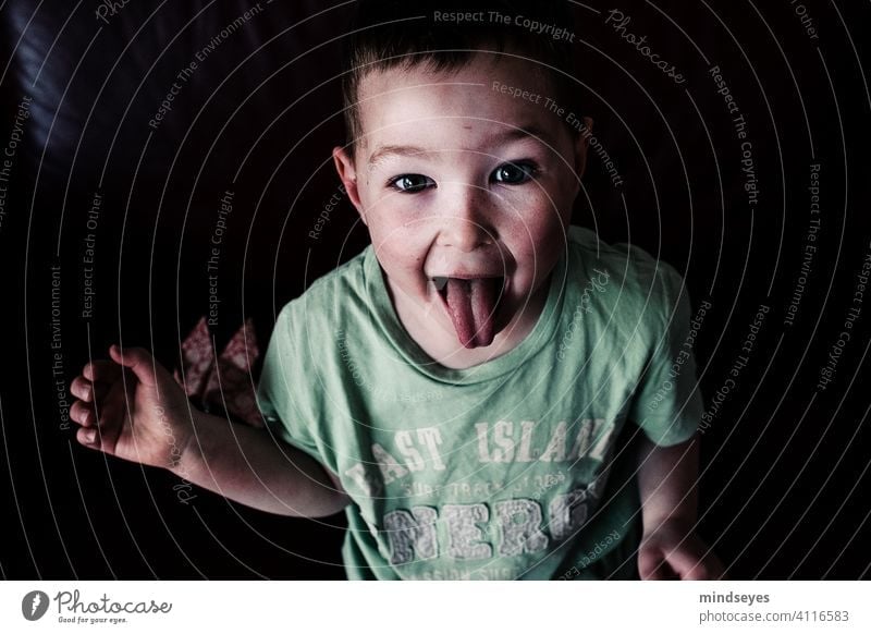 Naughty Boy Infancy Boy (child) Brash stick out one's tongue show tongue portrait Funny Face Grimace Looking into the camera Happiness Tongue Stick out Wild