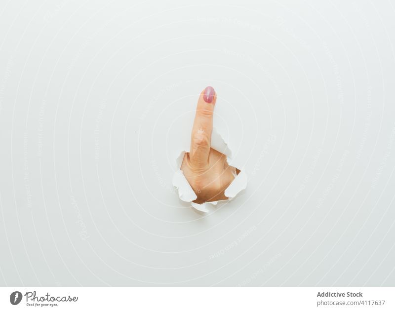 Hand With Thumb Up Through A Hole In Paper Stock Photo, Picture