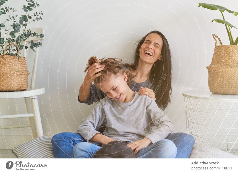 Happy woman with kid and dog at home mother together care happy cheerful hair cozy son parent child love play adorable lifestyle smile little fun bonding