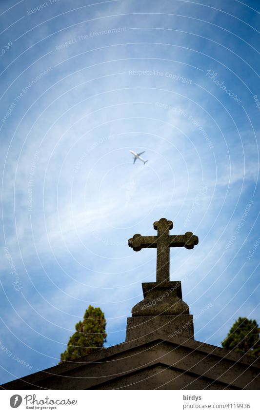 christian cross on a cemetery, above it flies a big passenger plane, frog perspective Crucifix Death pass away Christian cross Cemetery Religion and faith