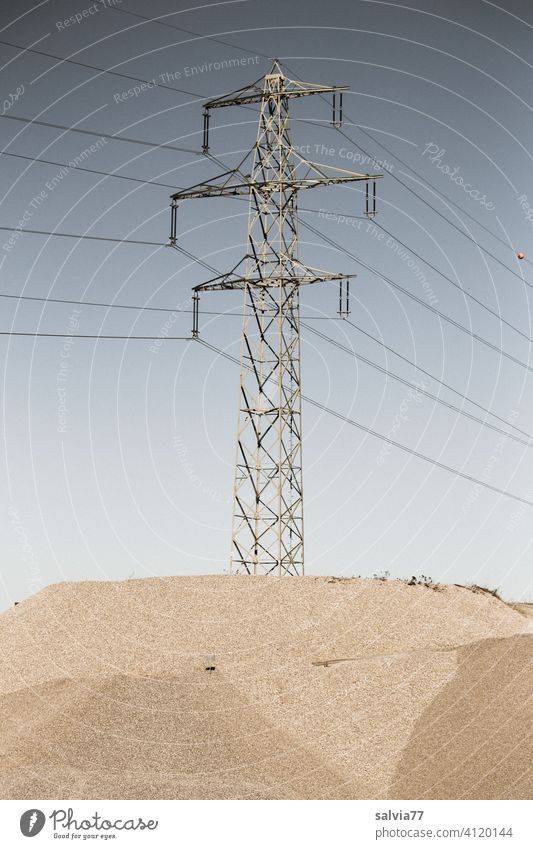 Power pole stands on an island in the gravel pit Energy industry gravel mining Gravel plant Industry Electricity High voltage power line Technology