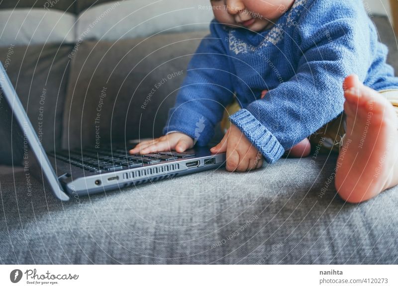 Close up of a baby using a laptop close up technology port usb hdmi keyboard hands touch touching pc computer home living room life lifestyle future progress