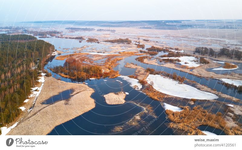 Spring melting river flood aerial panorama. Overflow water at springtime overflow deluge inundation floodwaters spate alluvion view environment beautiful forest