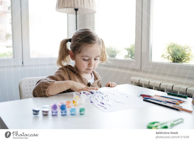 Little girl using gouache for drawing with fingers on paper at home child paint kindergarten creative kid cute education pencil learn elementary little adorable