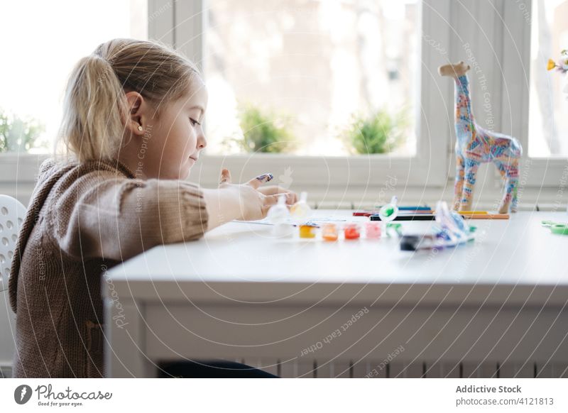 Little girl using gouache for drawing with fingers on paper at home child paint kindergarten creative kid cute education pencil learn elementary little adorable