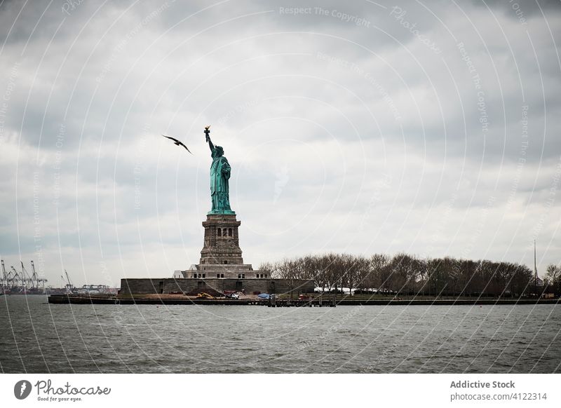 Statue of Liberty against cloudy sky statue liberty skyline overcast architecture symbol city landmark famous freedom new york bird usa america ny travel