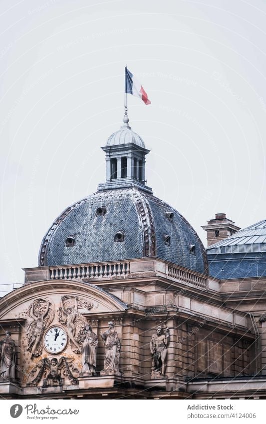 Roof of Luxembourg Palace with flying French flag on top palace wave monument architecture luxembourg palace famous paris luxembourg garden sightseeing clock