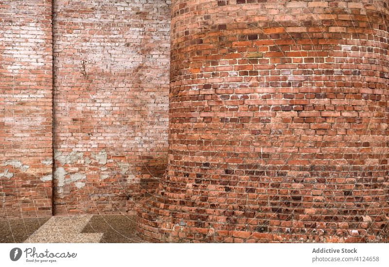 Exterior of shabby brick building of factory wall exterior grunge industrial rough architecture dirty sunny daytime facility weathered aged old structure
