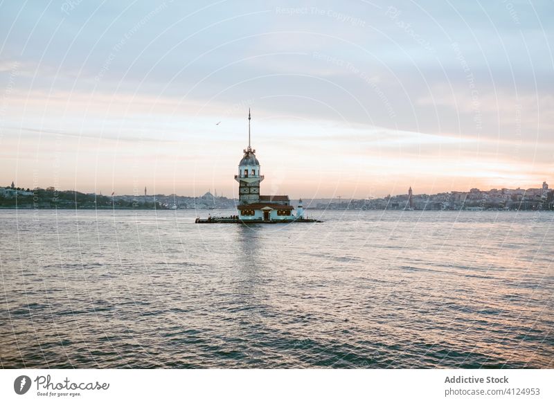 Cloudy sunset sky over sea and lighthouse distant calm sundown evening reflection breathtaking landscape harmony navigate magnificent amazing wonderful shore