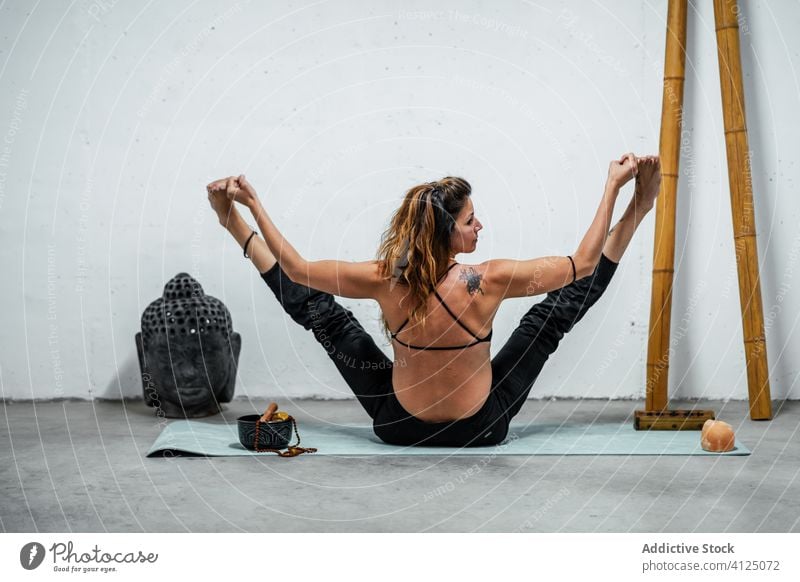 Flexible woman doing yoga in Boat pose - a Royalty Free Stock Photo from  Photocase