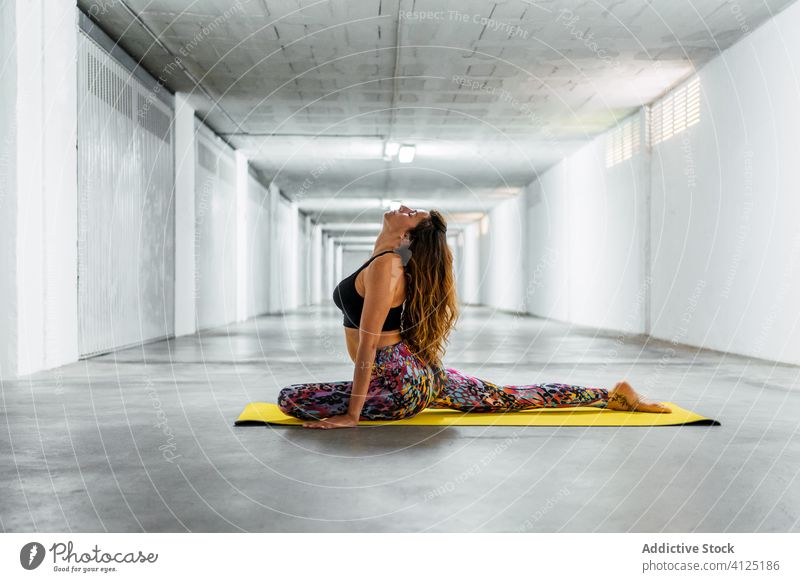 Slim Woman Practicing Yoga On A Mat Indoors Doing Pilates Stretching In A  Pose On The Floor High-Res Stock Photo - Getty Images