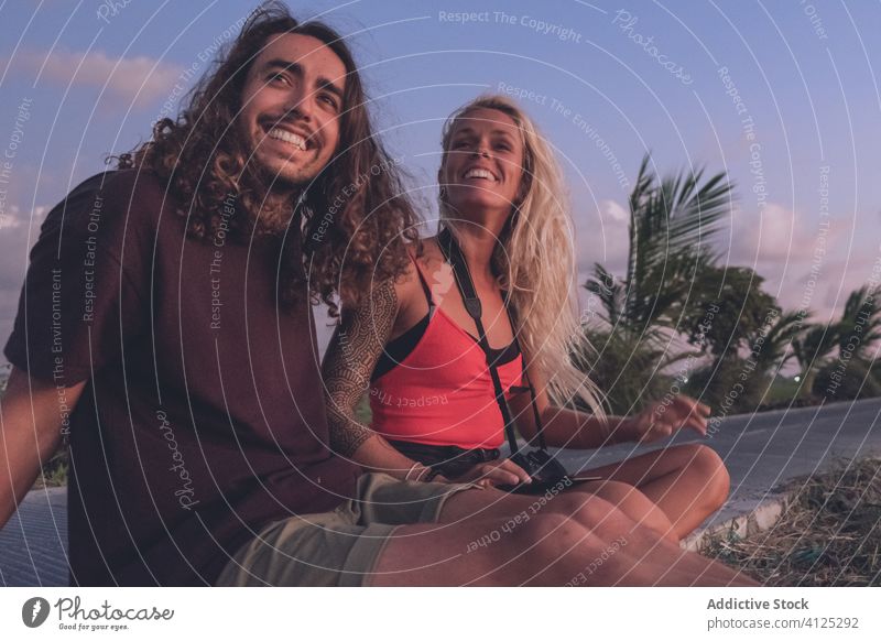 Delighted couple enjoying sunset during vacation evening traveler hipster roadside tropical sundown delight freedom inspiration content cheerful smile positive