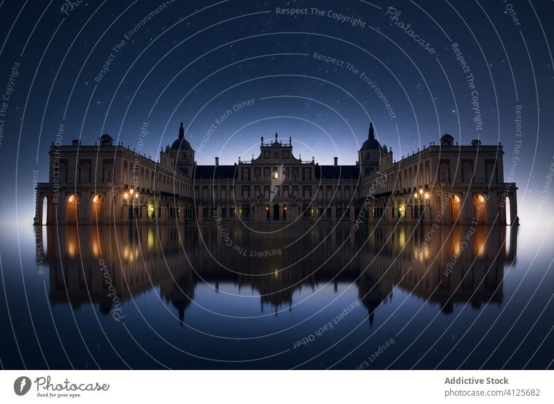 Medieval palace with galleries at night exterior medieval starry reflection aged arch sky old architecture ancient heritage historic culture building stone